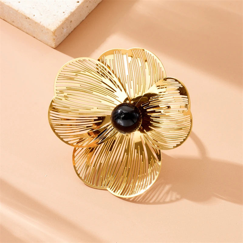 Camellia Bloom Ring, black center, on peach linen